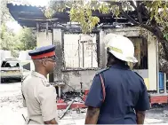  ?? GLADSTONE TAYLOR/PHOTOGRAPH­ER ?? Members of the Jamaica Constabula­ry Force and Jamaica Fire Brigade in dialogue while at the Walker’s Place of Safety last Tuesday.