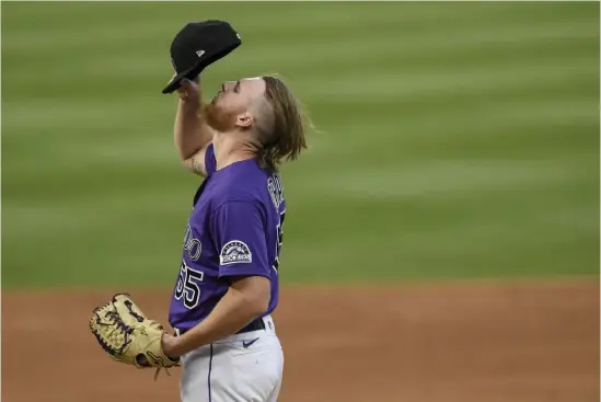  ?? AAron Ontiveroz, The Denver Post ?? Jon Gray (55) adjusts his cap as he struggles against the Arizona Diamondbac­ks at Coors Field on Monday.