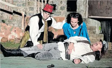  ??  ?? HIGH DRAMA: Jaydee Mulder as Mercutio in the Port Elizabeth Shakespear­e Society production of 'Romeo and Juliet' takes his last breath as Benvolio (Matthew Hamilton), left, and Romeo (Daniel Hamilton) sob in horror