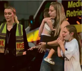  ?? RICK RYCROFT/ASSOCIATED PRESS ?? People were led away from Sydney’s Westfield Shopping Centre. A 9-month-old was among the injured.