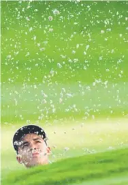  ??  ?? American Rickie Fowler watches his bunker shot onto the first green during the Ryder Cup on Friday in Gleneagles, Scotland. Matt Dunham, The Associated Press