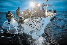  ?? U.S. NAVY VIA THE ASSOCIATED PRESS ?? U.S. navy sailors recover the remnants of an alleged Chinese surveillan­ce balloon that was shot down off South Carolina.