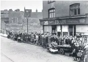  ??  ?? Root problem: women in Camberwell, south London, queue for potatoes as the potato shortage hits the capital