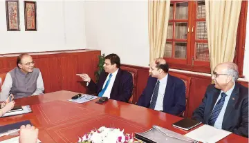  ?? PTI ?? Union Finance Minister Arun Jaitley (left) talks to Reserve Bank of India (RBI) Governor Urjit Patel (second from left) during a meeting with the officials of Department of Financial Services and RBI in New Delhi on Friday.