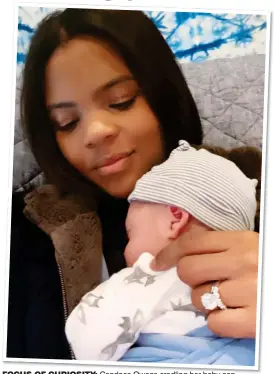  ??  ?? FOCUS OF CURIOSITY: Candace Owens cradling her baby son