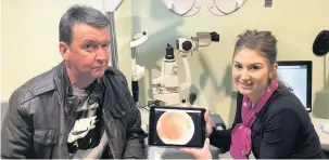  ??  ?? Lifesaver Edward with Specsavers Coatbridge optometris­t Stephanie Duff