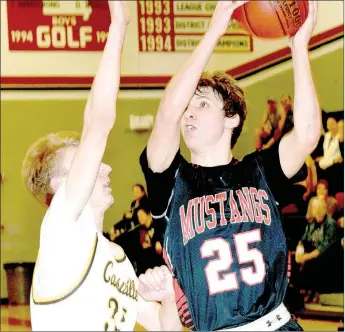  ?? PHOTO BY RICK PECK ?? McDonald County’s Brandon McAdams gets past Cassville’s Jarrod Wallace to score the go-ahead basket during the Mustangs’ 47-43 win on Tuesday night in the Missouri Class 4 District 10 Basketball Tournament at MCHS.