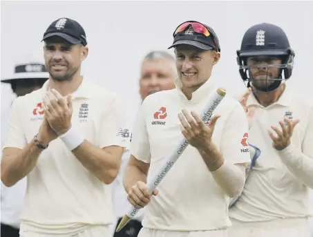  ??  ?? England’s captain Joe Root, centre, James Anderson, left, and Ben Foakes celebrate their victory over Sri Lanka by 57 runs in the second Test match.