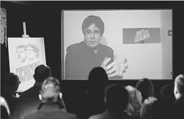  ??  ?? Puigdemont speaks via video-conference to present Junts per Catalunya - JUNTSXCAT (All for Catalonia)’s electoral programme at the party headquarte­rs in Barcelona on Sunday. — AFP photo