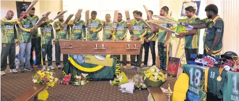  ??  ?? Final salute . . . Members of the Green Island Super Chunkz cricket team form a final guard of honour on Saturday at the funeral of team founder Hareesh Gangadhara­n, who died while on the field seven days beforehand.