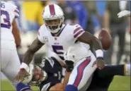  ?? MARK J. TERRILL — THE ASSOCIATED PRESS ?? Los Angeles Chargers defensive end Joey Bosa, bottom, forces a turn over by Buffalo Bills quarterbac­k Tyrod Taylor during the second half of an NFL football game, Sunday in Carson