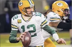  ?? Nam Y. Huh / Associated Press ?? Packers quarterbac­k Aaron Rodgers could be seeing a lot of the Rams’ defense chasing after him on Saturday.