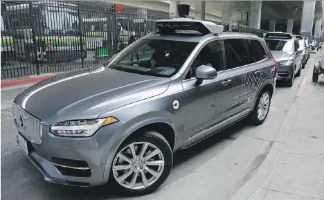  ?? ERIC RISBERG/THE ASSOCIATED PRESS FILES ?? A self-driving Volvo Uber heads out for a test drive in San Francisco last December. Ride-hailing firm Uber Technologi­es and Volvo were among companies that formed partnershi­ps last year to take advantage of the driverless revolution.