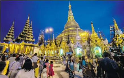  ?? PHOTOS: RICHARD CAMP/THE ASSOCIATED PRESS ?? The golden dome of the Shwedagon Pagoda is visible throughout much of the city of Yangon, Myanmar, and attracts crowds seeking a closer look.