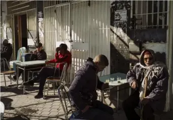  ??  ?? Locals congregate at a café in Kasserine's city centre