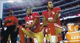  ?? ASSOCIATED PRESS FILE PHOTO ?? San Francisco’s Eric Reid, center, and Colin Kaepernick kneel during the national anthem in September of 2016 to promote civil rights and decry police misconduct.