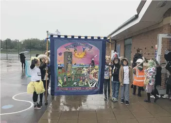  ??  ?? Children of Easington Colliery Primary School getting ready to take part in their parade in the rain.