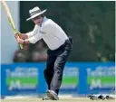  ??  ?? Umpire Asad Rauf tries a shot at the water break