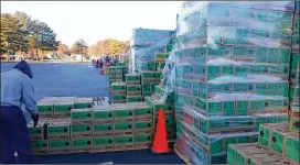  ?? COURTESY ?? A warehouse worker checks a load of Girl Scout cookies for loading into a warehouse in metro Atlanta.