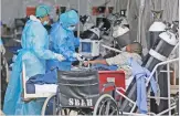  ?? (AFP) ?? Healthcare staff attend to a patient inside the temporary ward at Steve Biko Academic Hospital, in Pretoria on Monday