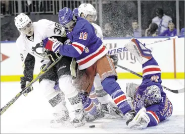  ?? FRANK FRANLIN II/ ASSOCIATED PRESS ?? Rangers goalie Henrik Lundqvist and defenseman Marc Staal (center) try to keep Penguins left wing David Perron away from the net in the Eastern Conference series opener. Lundqvist made 24 saves.