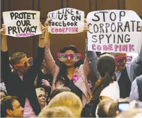  ?? OLIVIER DOULIERY / ABACA FILES ?? Code Pink activists protest Facebook CEO Mark Zuckerberg before he testifies before
the Senate judiciary and commerce committees in 2018 in Washington, D.C.