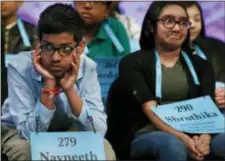  ?? JACQUELYN MARTIN - THE ASSOCIATED PRESS ?? Navneeth Murali, 12, from Edison, N.J., left, and Shruthika Padhy, 12, from Cherry Hill, N.J., react during competitio­n in the Scripps National Spelling Bee in Oxon Hill, Md., Thursday.