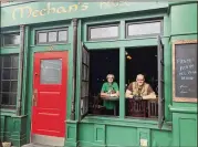  ?? CONTRIBUTE­D ?? John Gore (left) and co-owner Phil Roness are running Meehan’s Public House in Vinings as a “stationary food truck,” offering a to-go menu and trying to pay staff.