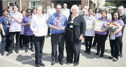  ??  ?? The team at Franklin House care home in West Drayton celebrate receiving the NHS award