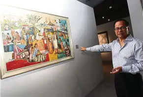  ??  ?? Ken Gallery founder Datuk Kenny Tan points out one of his favourite pieces, an untitled 1959 work by Chia Yu Chian. — NORAFIFI EHSAN/The Star
