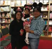  ?? MICHAEL GWIZDALA — MGWIZDALA@DIGITALFIR­STMEDIA.COM ?? Razia and Almgier Arif and their daughter Tashafia, of Saratoga Springs, celebrate Fall Fest with Mickey and Minnie Mouse costumes at Northshire Bookstore.