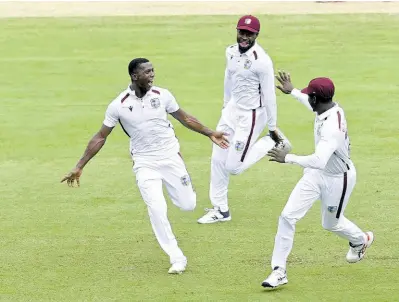  ?? AP ?? West Indies fast bowler Shamar Joseph (left) celebrates with teammates after taking the wicket of Australia’s Travis Head on the fourth day of the second Test in Brisbane on Sunday, January 28, 2024.