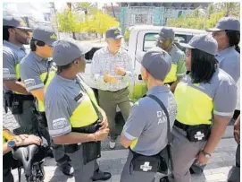  ?? PHOTOS BY JOE BURBANK/STAFF PHOTOGRAPH­ER ?? City commission­er Robert Stuart talks with new downtown ambassador­s, who will offer safety escorts, directions, report suspicious activity and curb aggressive panhandlin­g.