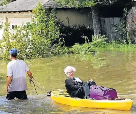  ?? /AFP Photo ?? On to dry land: A woman is evacuated on a canoe as people escape flood waters in Lakeside Estate in Houston, Texas, on Wednesday.