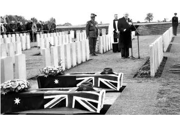  ??  ?? Cosgrove delivers a speech at the Queant Road cemetary during the burial of two soldiers belonging to the 24th Australian Imperial Force infantry battalion killed during World War I in Buissy, Northern France, as nations commemorat­e the 100th anniversar­y of the Armistace of Nov 11, 1918. — AFP photo