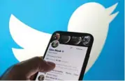  ?? (AFP) ?? This illustrati­on photo displays Elon Musk’s Twitter account with a Twitter logo in the background in Los Angeles