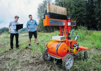  ?? JASON PAYNE/PNG ?? University of Victoria students Tyler Rhodes, left, and Nick Birch have constructe­d a tree-planting robot called the TreeRover, which could eliminate thousands of temporary tree-planting jobs in B.C. alone.