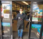  ?? Jason Armond Los Angeles Times ?? AT RALPHS in Westcheste­r on March 22, a worker stands at the door to allow only a few shoppers at a time to enter because of distancing guidelines.