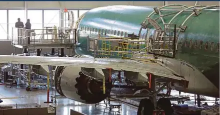  ?? REUTERS PIC ?? A Boeing 737 MAX-9 under constructi­on at a production facility in Renton, Washington in 2017. The plane maker says it has made efforts to reduce the amount of planes moving down the assembly line with jobs still needing to be fixed from earlier work stations.