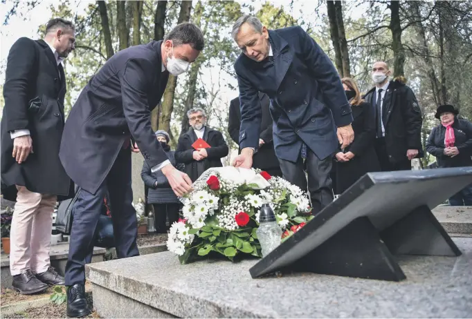  ?? FOTO – TASR ?? Trojicu popravenýc­h si tento rok uctil na Martinskom cintoríne s Jánom Figeľom aj premiér Eduard Heger.