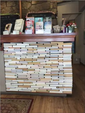  ?? TRACEE M. HERBAUGH VIA AP ?? The check-out counter at the indie bookseller Newtonvill­e Books in Newton, Mass. The counter is made of rows of backwards books glued into place.