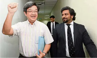  ??  ?? Happy man: Tan (left) with his lawyer Dev walking out the Sessions Court in Butterwort­h.