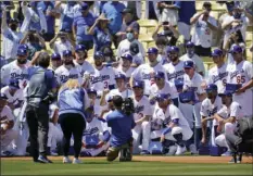  ?? JOSE SANCHEZ
AP PHOTO/MARCIO ?? Members of the Los Angeles Dodgers pose for photos with their 2020 World Series Championsh­ip rings before a baseball game against the Washington Nationals Friday in Los Angeles.