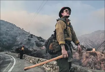  ?? Photograph­s by Robert Gauthier Los Angeles Times ?? JESSY TWIN, a firefighte­r from Mormon Lake, Ariz., looks over charred hillsides Monday in Arcadia. Twin said his crew was on its sixth day of cutting lines in the Bobcat fire, which ignited in Angeles National Forest.