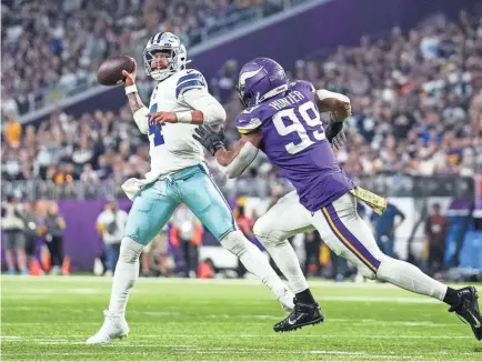  ?? BRACE HEMMELGARN/USA TODAY SPORTS ?? Cowboys quarterbac­k Dak Prescott throws over Vikings linebacker Danielle Hunter during the third quarter of the rout at US Bank Stadium.