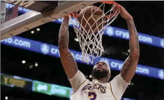  ?? ERIC THAYER — THE ASSOCIATED PRESS ?? The Lakers' Anthony Davis dunks for two of his 27points in Sunday night's victory over the Minnesota Timberwolv­es at Crypto.com Arena. Davis also had 25rebounds, five assists and three blocked shots.