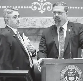  ?? David Zalubowski, The Associated Press ?? COLORADO FIREARMS LAW State Sen. Chris Holbert, R-Highlands Ranch, left, confers with Senate President Kevin Grantham, R-Cañon City, during debate on a concealed-carry bill on the floor of the chamber Thursday at the Capitol.