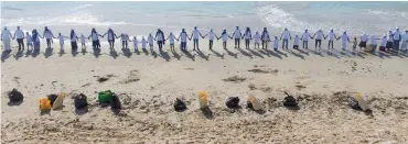  ?? (Supplied photos) ?? Volunteers after cleaning up the beach in Ras al Ruwais