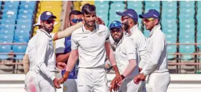  ?? — PTI ?? Saurashtra’s Chirag Jani (centre) is applauded by his teammates for dismissing Bengal’s Manoj Tiwary during the Ranji final at Rajkot on Wednesday.