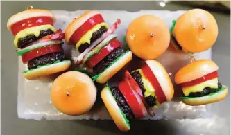  ??  ?? TOKYO: Photo shows plastic hamburger earrings made at the studio of Fake Food Hatanaka in Tokorozawa, a suburb of Tokyo. —AFP photos